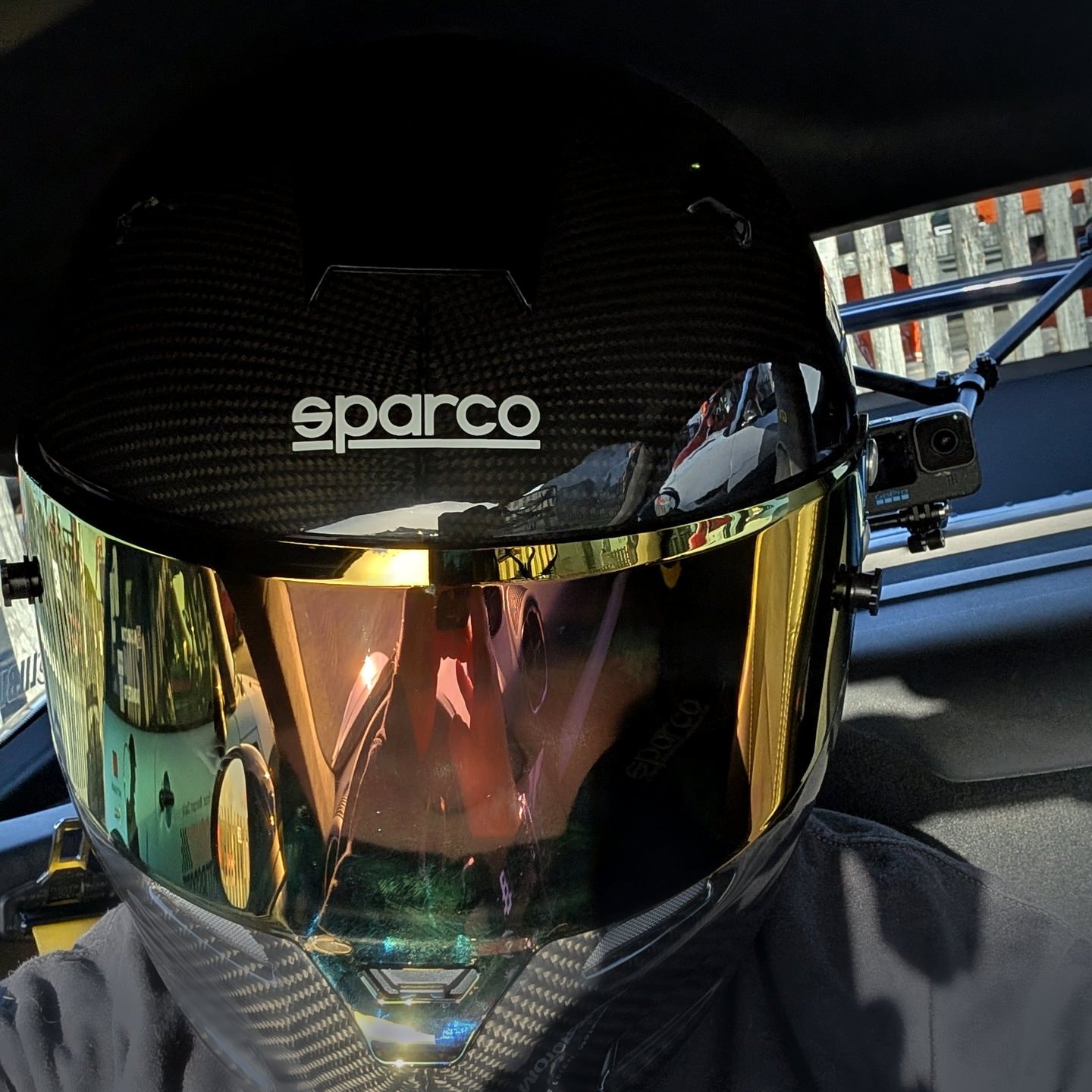 Jonathan Ward in his helmet in the car, with the Kalman filter, braking and grip maths appearing around him